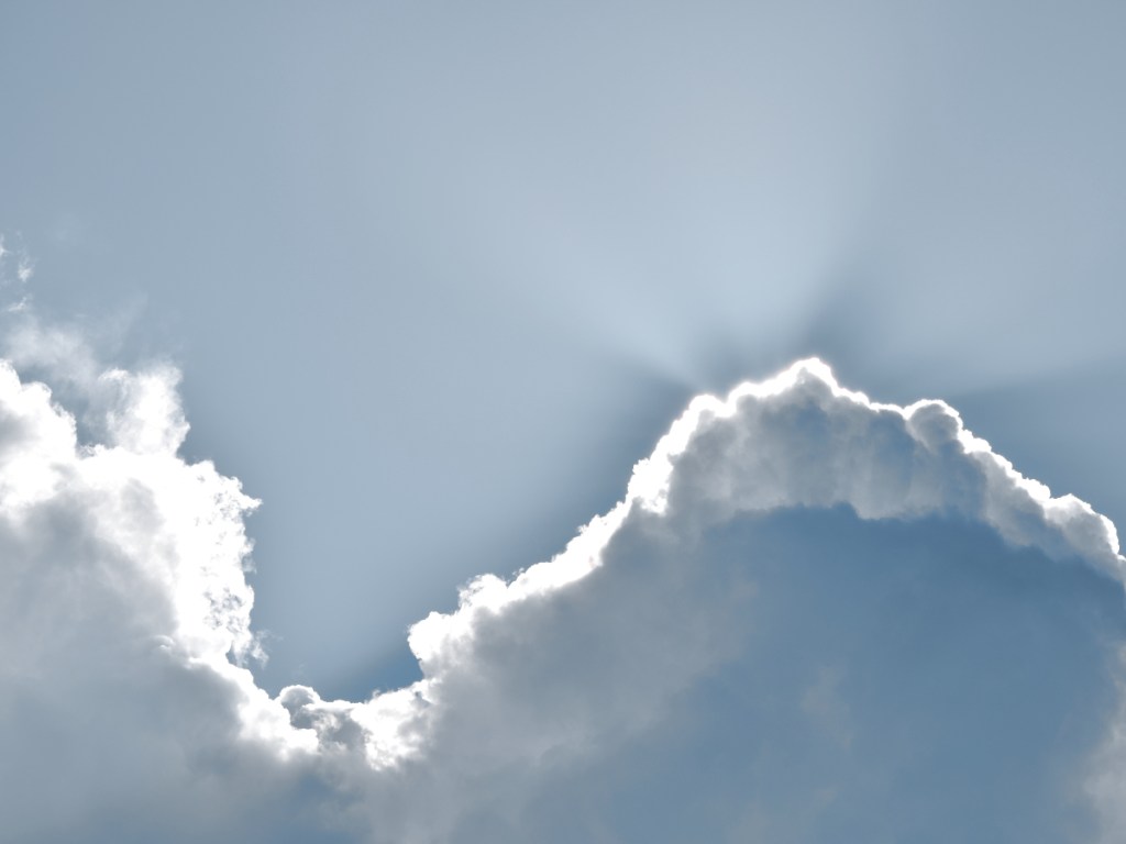 Sunrays peeking through the clouds over the beach at Chioggia, Italy.