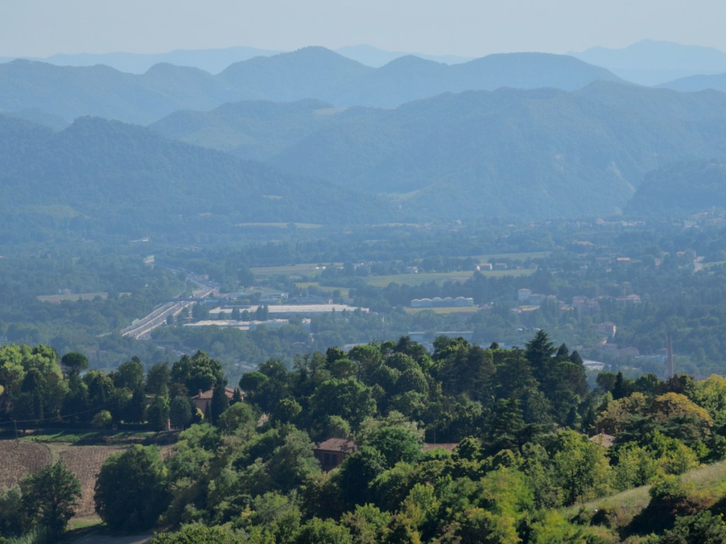 A valley close to Bologna, Italy, revealing a highway and forest areas.