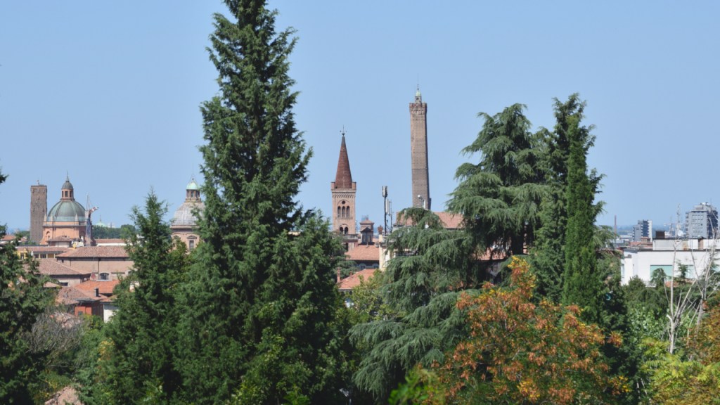 A close-up cityscape of Bologna, Italy with some towers in the distance.